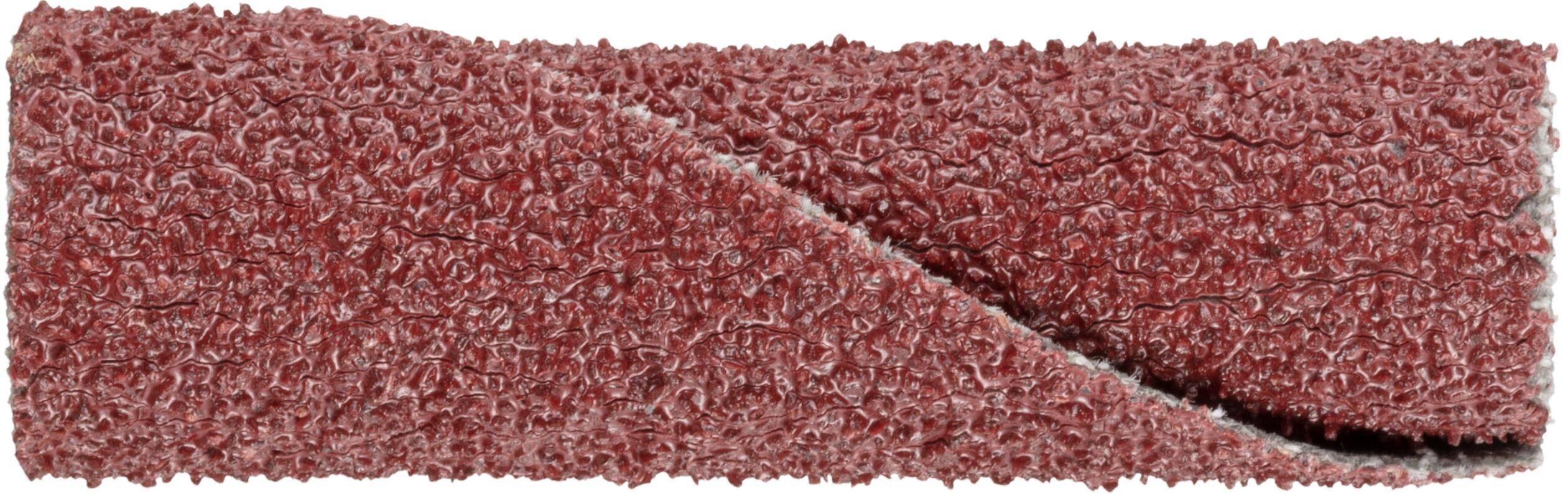 Close-up of a red-brown, textured abrasive strip, possibly sandpaper, with a visible crease.