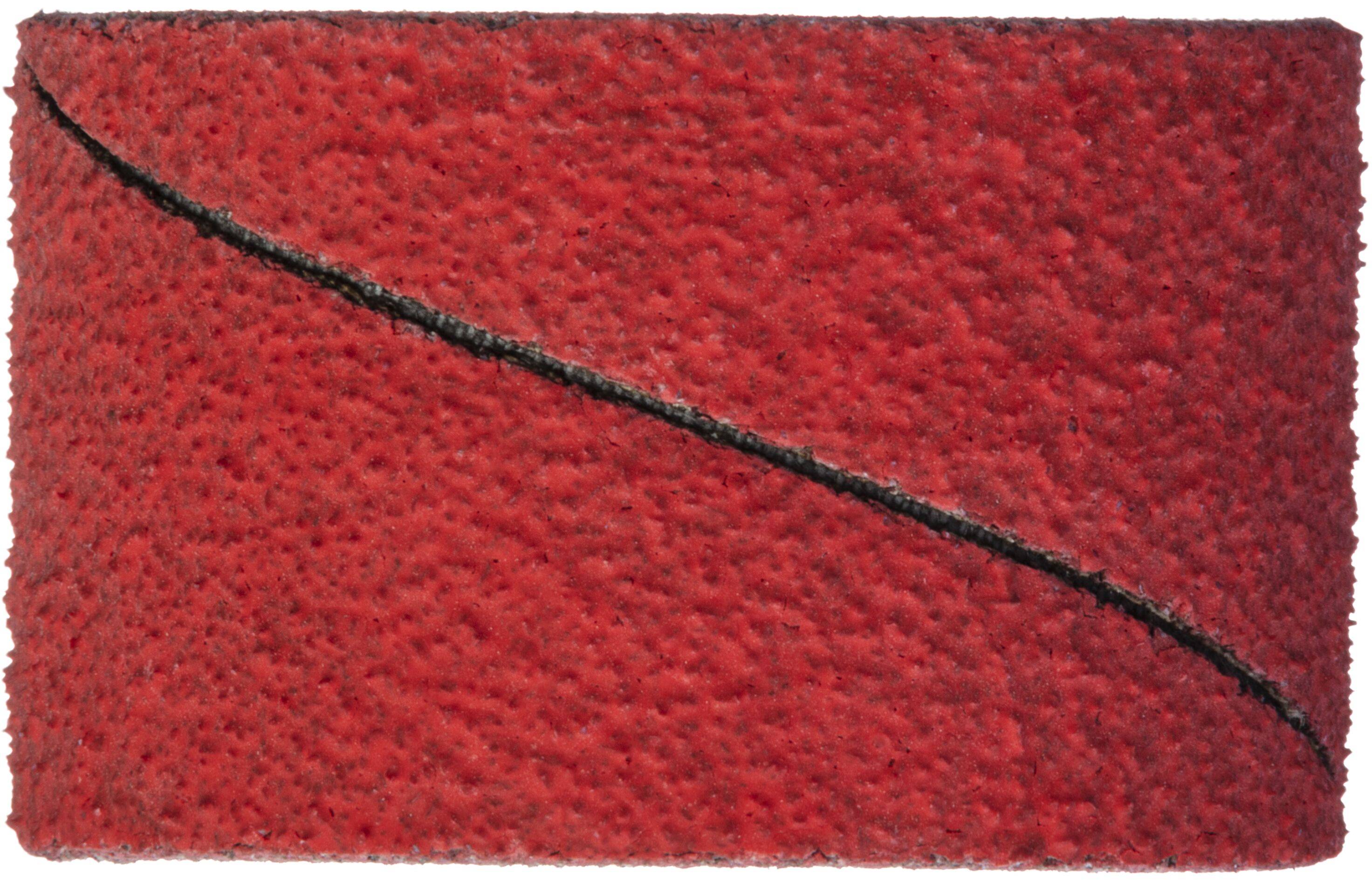 A red textured plush surface with a diagonal black line stretching from the bottom left to the top right corner.