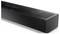 A sleek, black soundbar with control buttons on the top, featuring a minimalist design and vented speaker areas, against a white background.