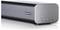A sleek gray soundbar with a 'Dolby Atmos' label on the front, featuring control buttons on the side, designed for enhanced audio experiences.