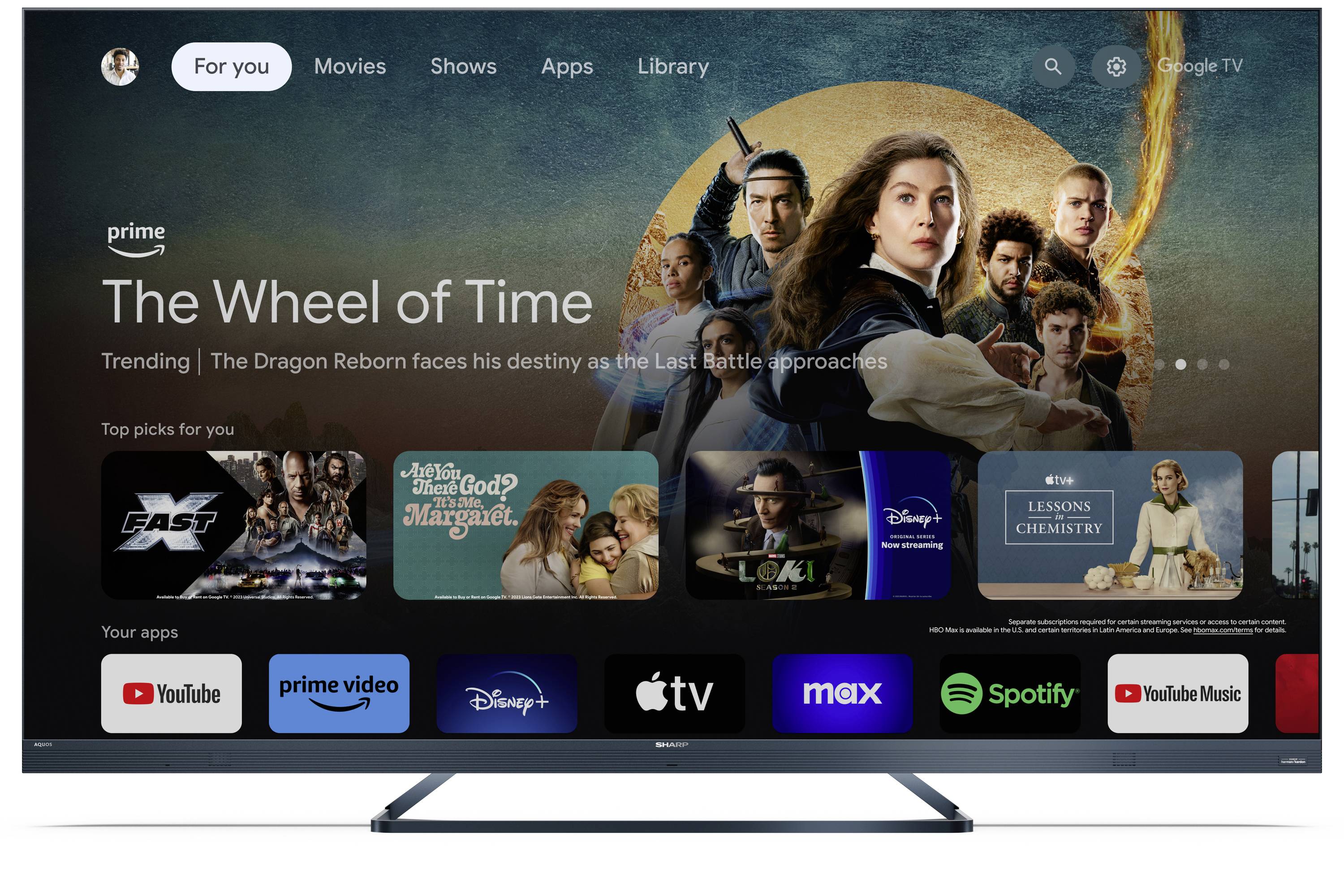 A TV screen displays a streaming interface featuring 'The Wheel of Time' as the highlighted show, along with various app icons below.