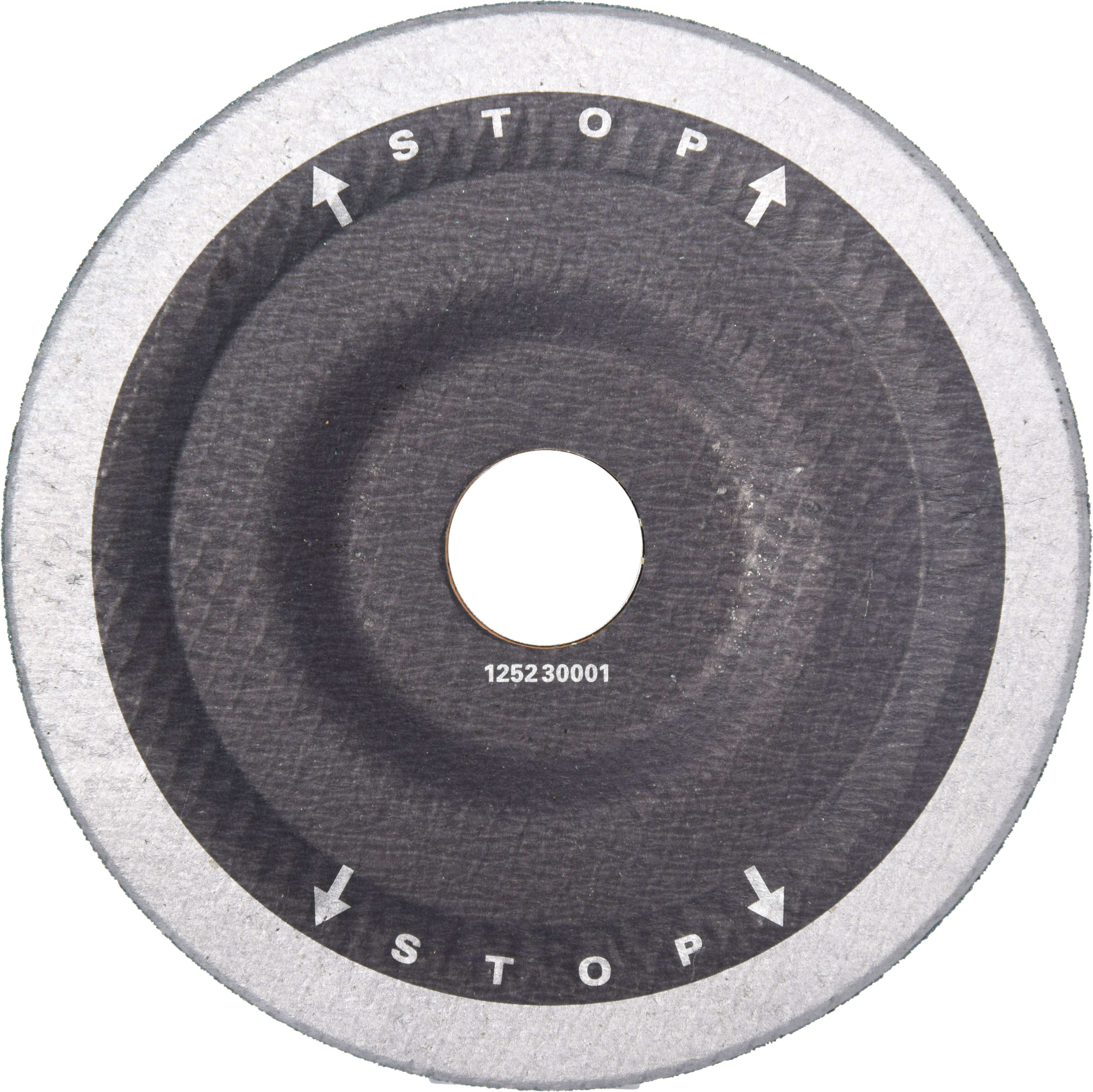 'A round, black abrasive disc with the word STOP and arrows pointing in opposite directions around the center hole.'