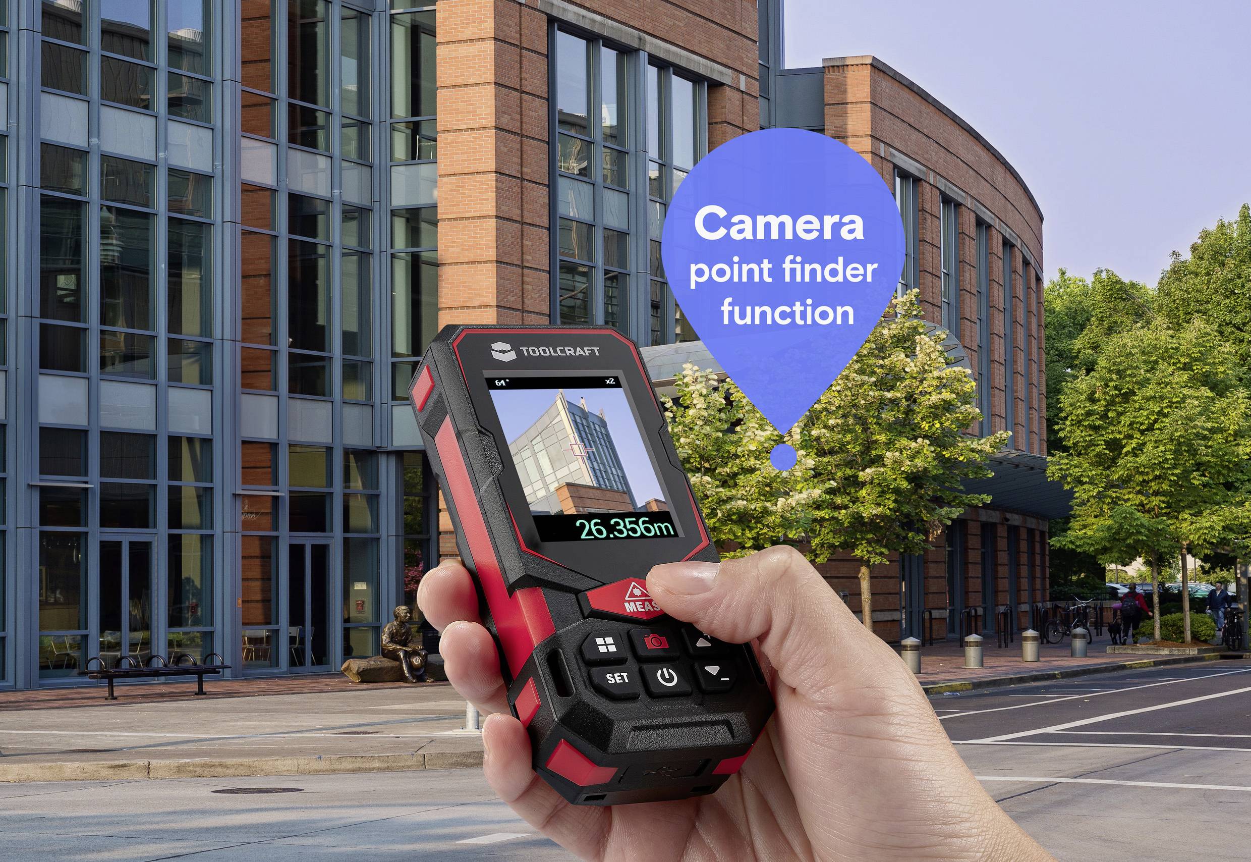 Hand holding a laser distance meter with building in viewfinder, showing 'Camera point finder function' in a text bubble.