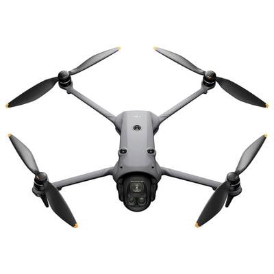 A grey drone with four propellers, equipped with a camera, is shown from above.