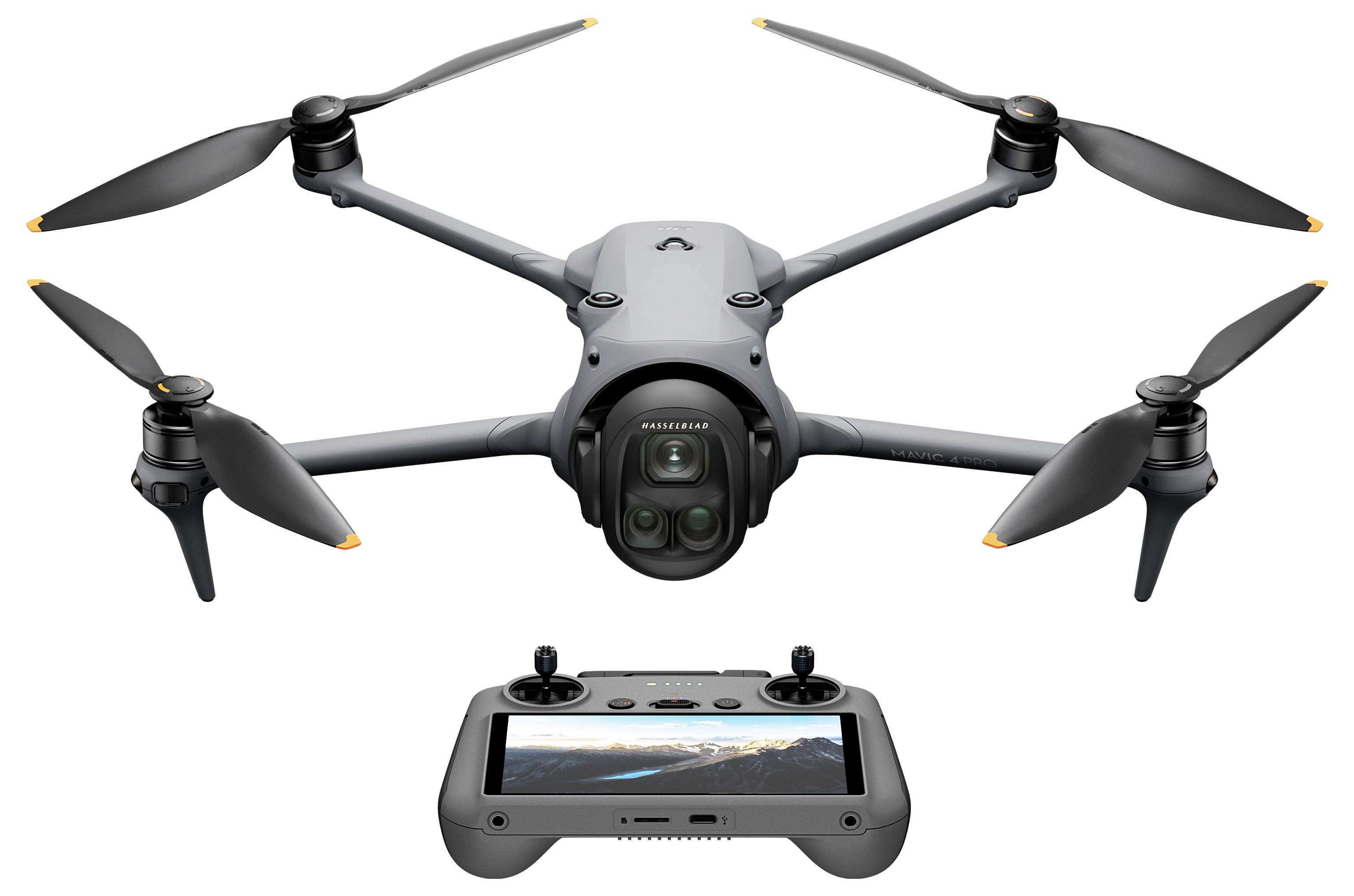 A sleek, black drone with four propellers; below it, a remote control featuring a display screen showing a landscape photo.