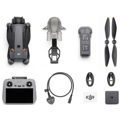Top-down view of a drone kit including the drone, battery, propellers, controller, power cable, and additional accessories neatly arranged.