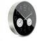 A wall clock with a black face, large white numerals, and two smaller dials showing humidity and temperature.