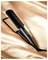 A black flat iron on a satin peach background, branded 'Remington Air Plates', showcasing its sleek design and wide ceramic plates.