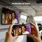 Person holding a smartphone displaying a couple's photo, mirrored on a TV in a modern living room. German text promotes streaming content.