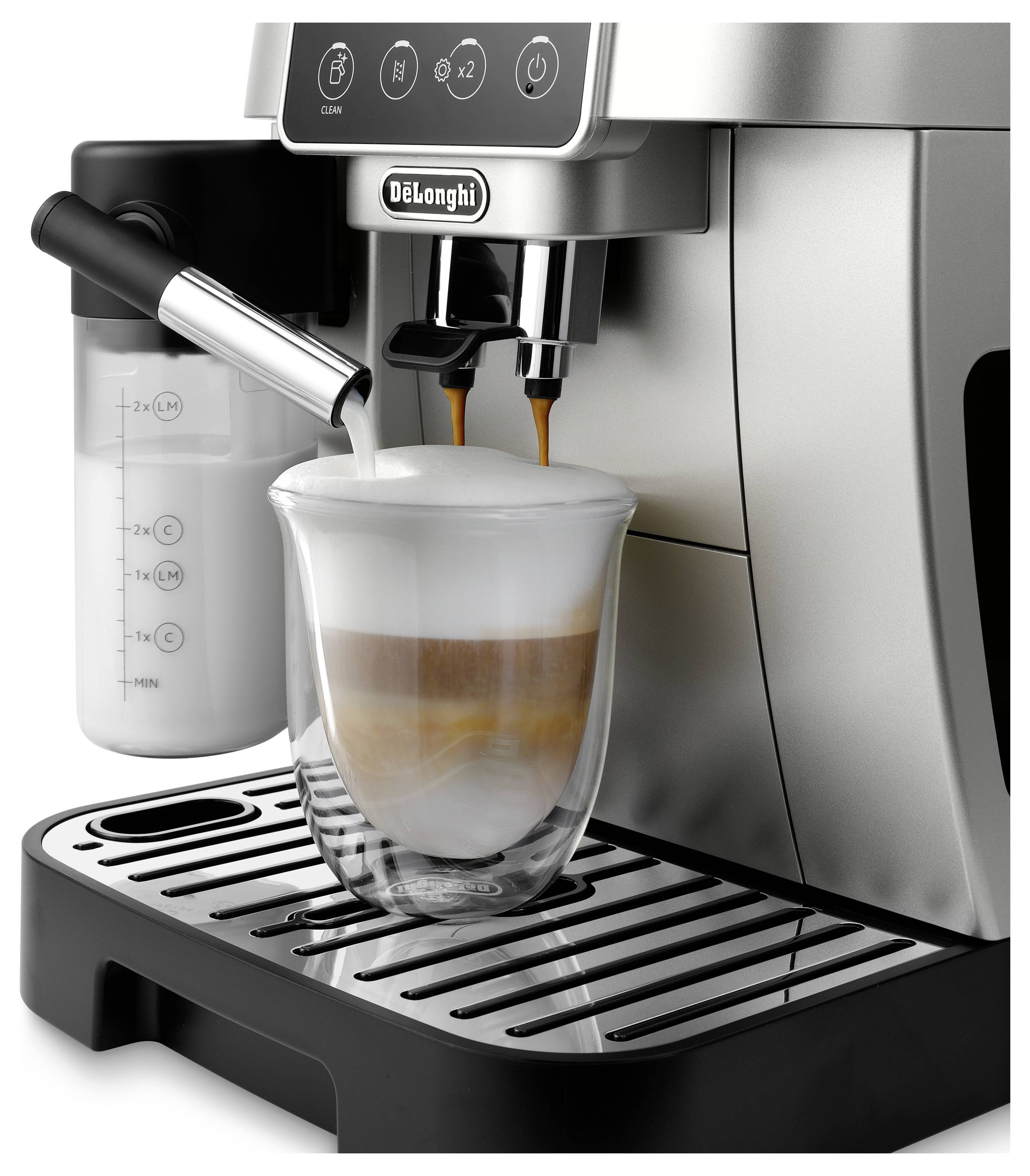 An espresso machine preparing a cappuccino, with milk frother in action, dispensing coffee into a clear glass mug on a drip tray.