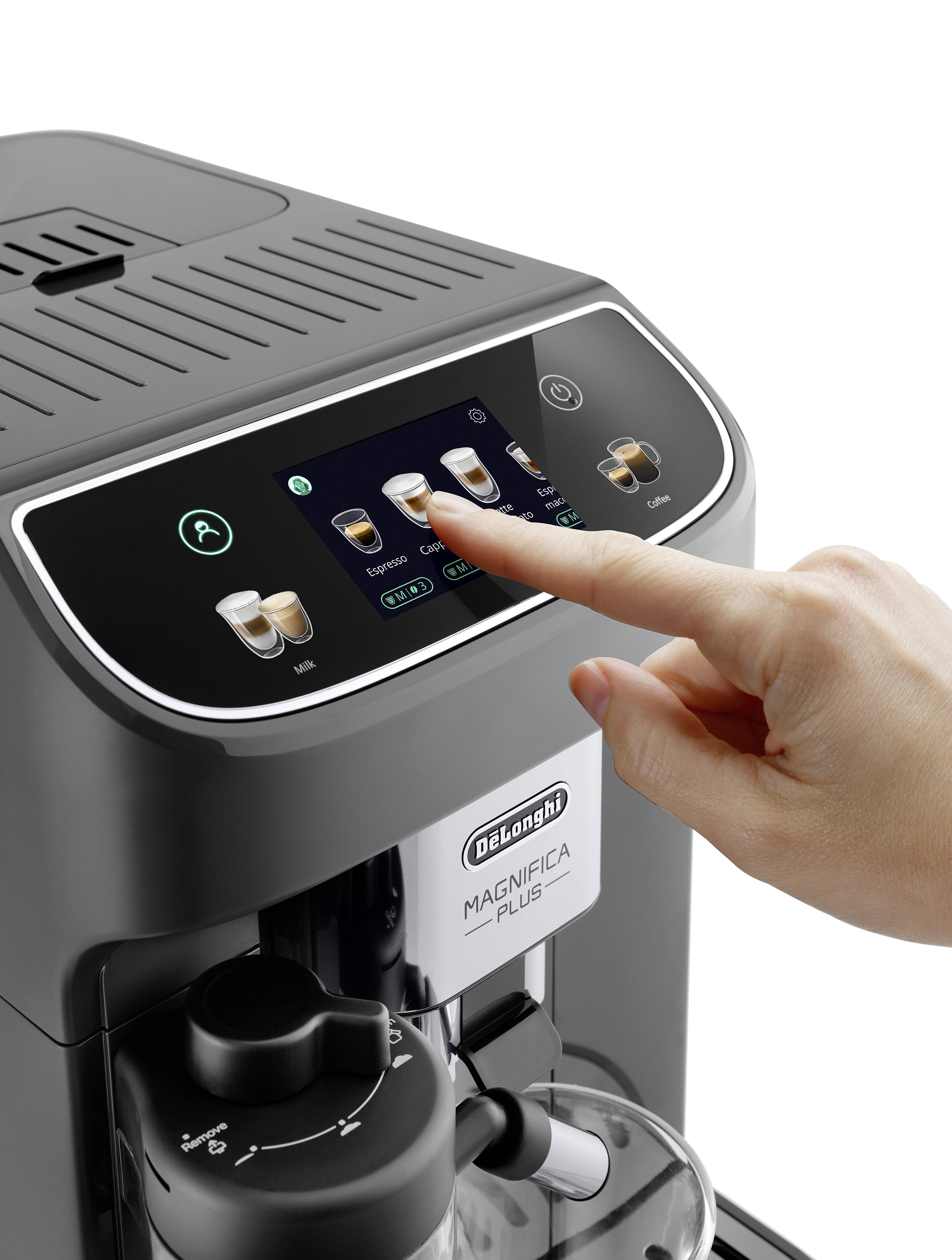 A person selects a coffee option on the touchscreen of a modern coffee machine labeled 'Magnifica Plus'. The machine has various buttons and indicators.