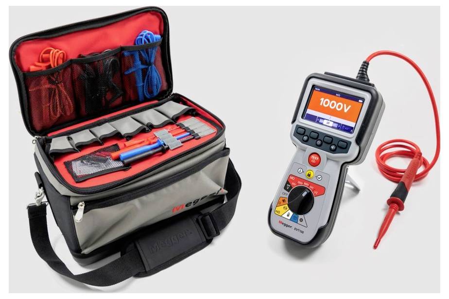 A digital multimeter with a test probe wire, positioned next to an open toolkit containing various cables and connectors.