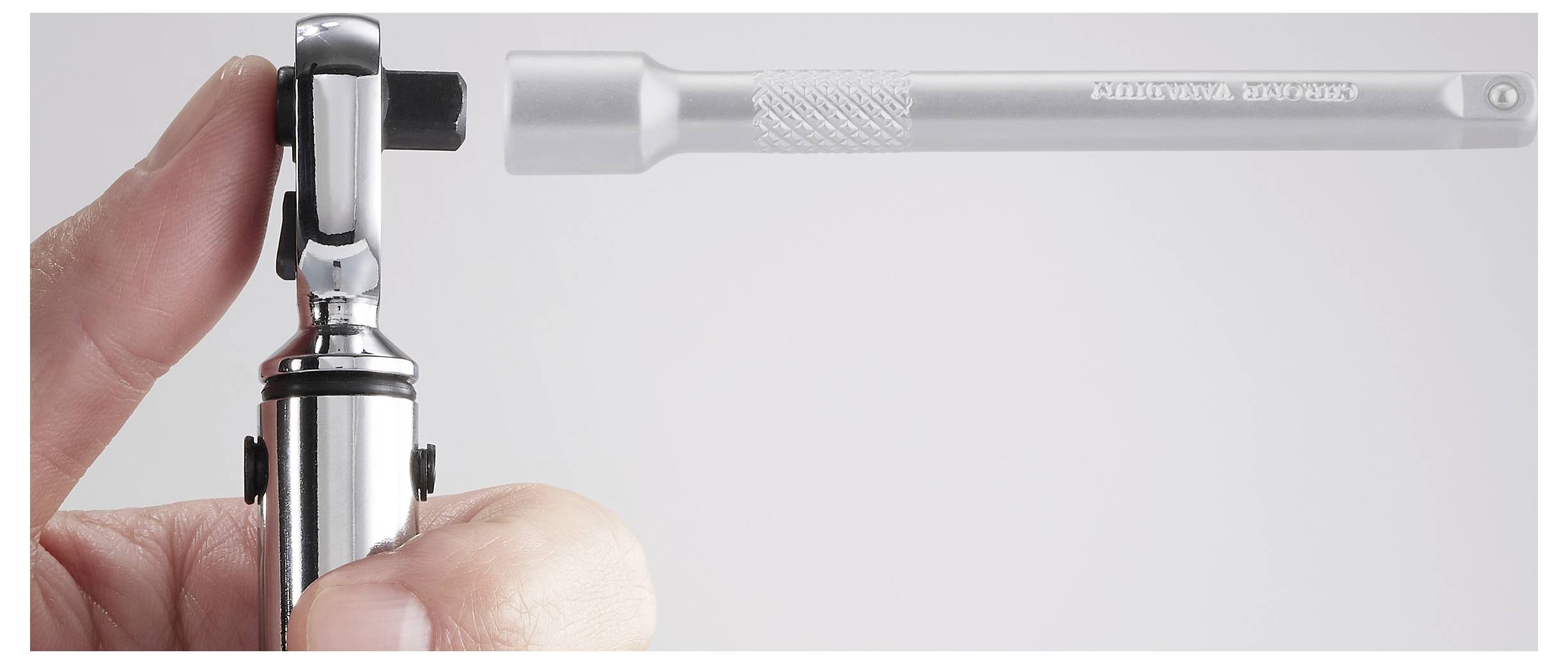 'Shinwa' brand torque wrench held by a hand, showcasing its adjustable ratchet head and chrome finish against a plain background.