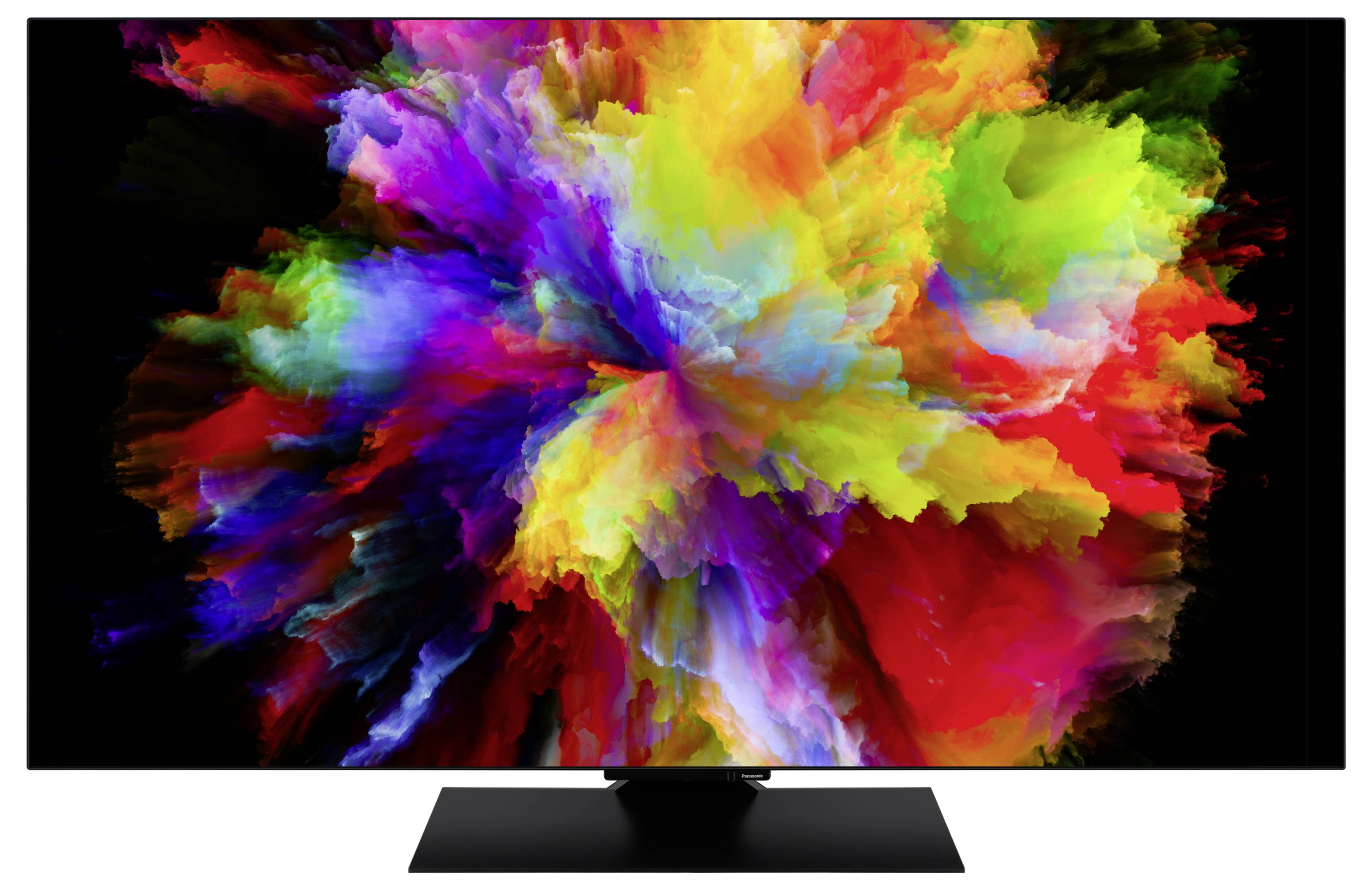 A splash of vibrant colors, including red, yellow, green, and blue, exploding outwards against a black background, creating an abstract art effect.