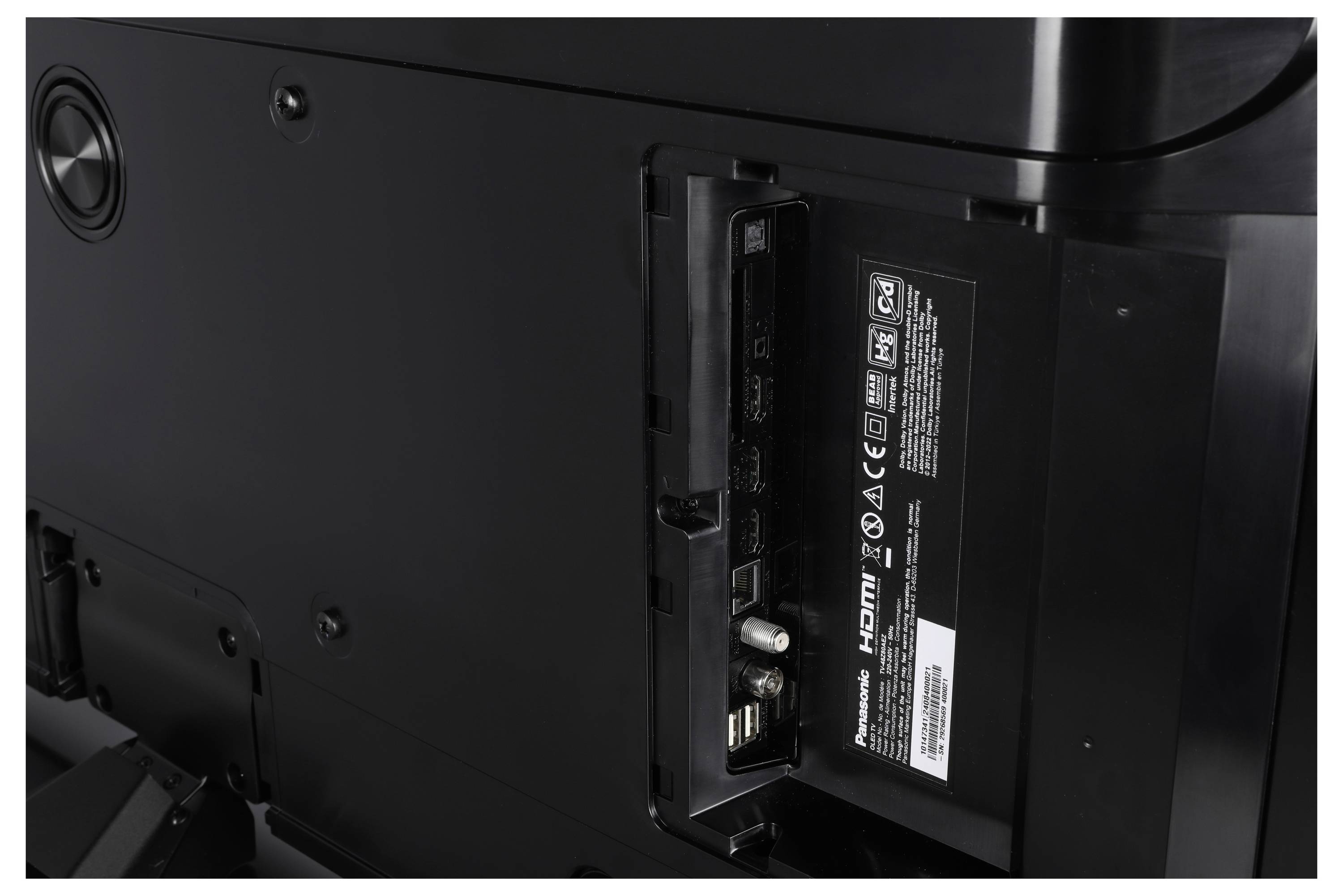 Back of a TV showing ports including HDMI, USB, and coaxial, with a label indicating input options.