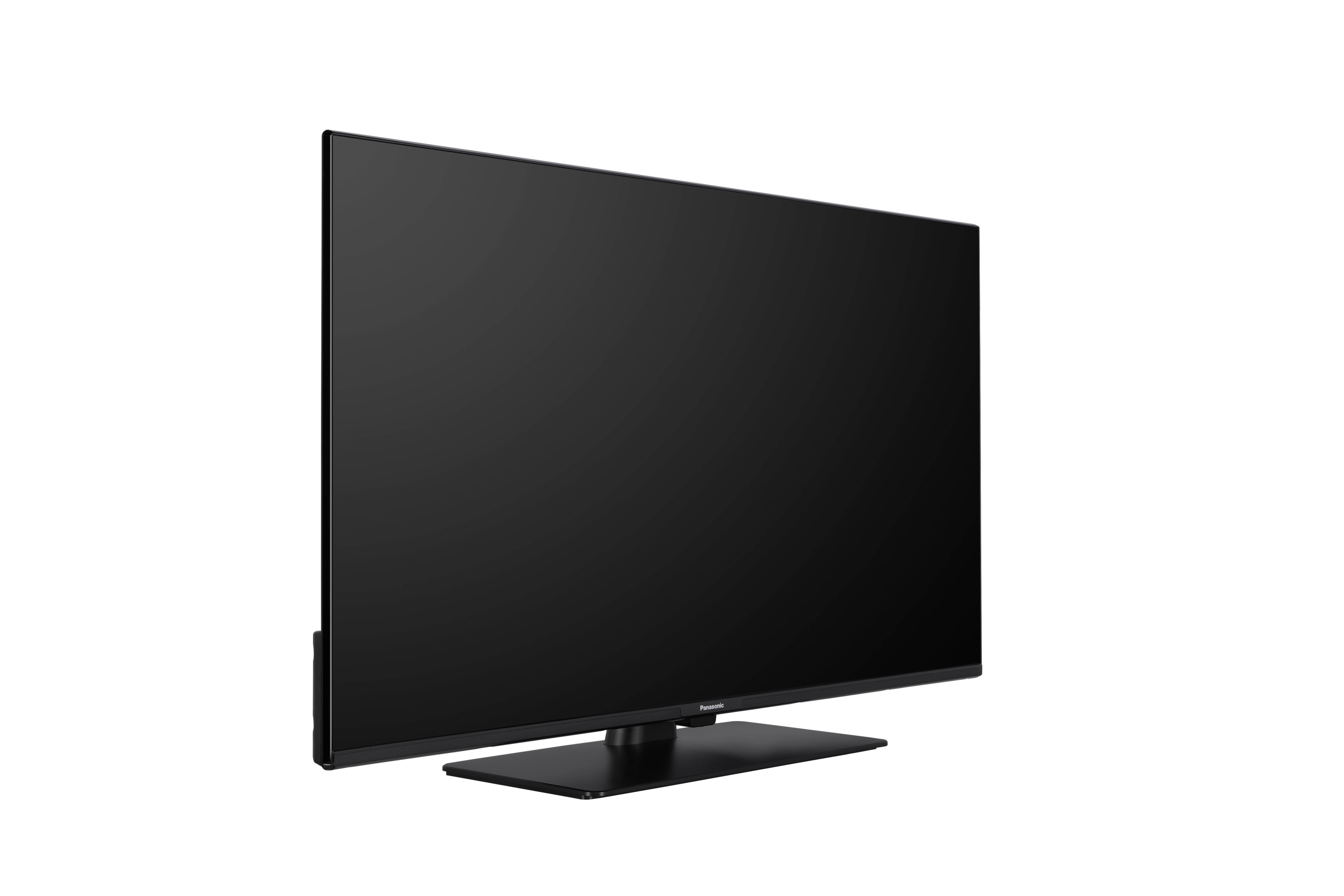 A flat screen television with a black frame, shown from a side angle on a white background. The screen is off, reflecting light.