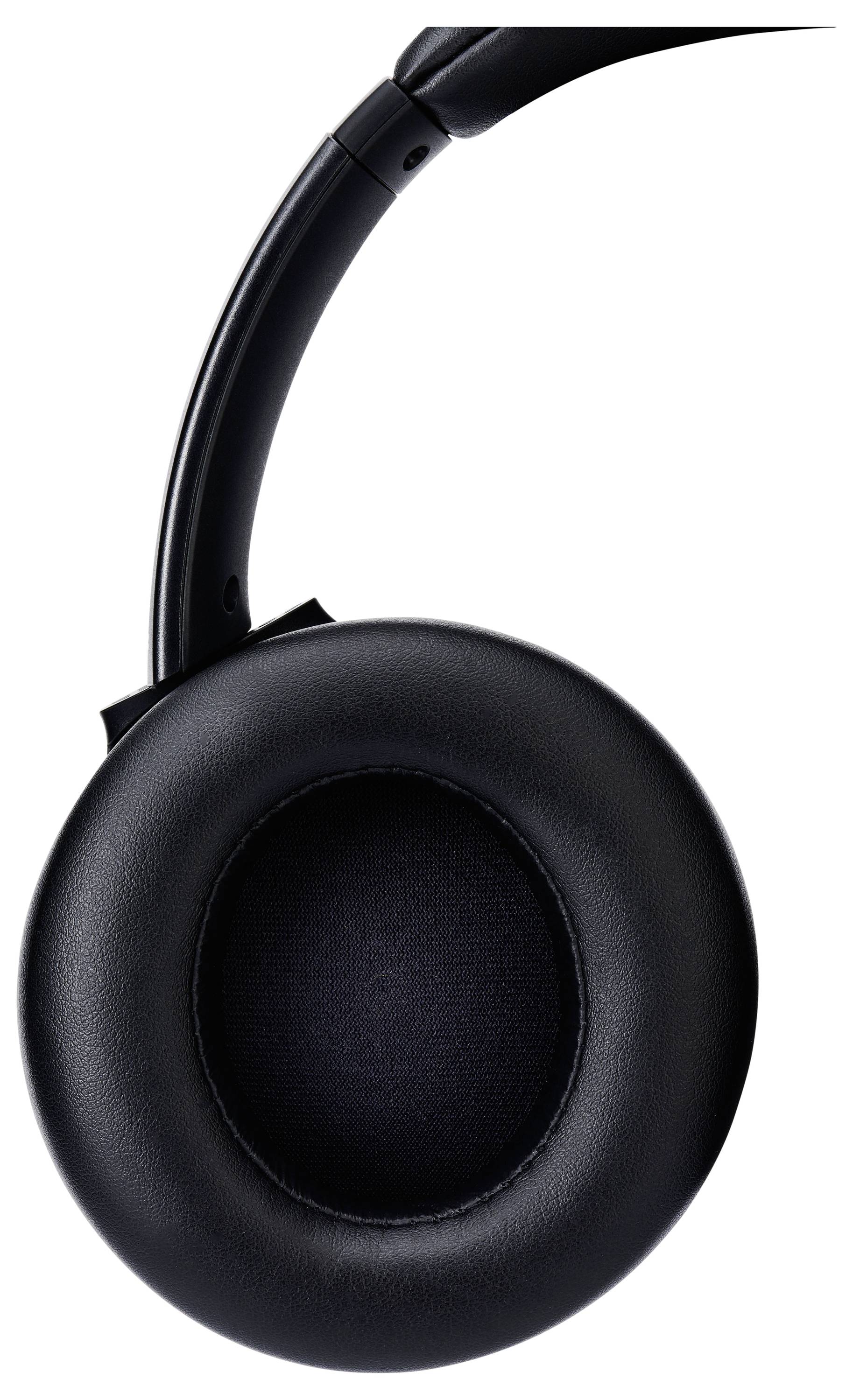 A black over-ear headphone earcup shown in close-up, highlighting its padded cushion and smooth design.