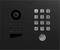 A black intercom panel with a camera, numeral keypad, and call button, likely used for access control at building entrances.