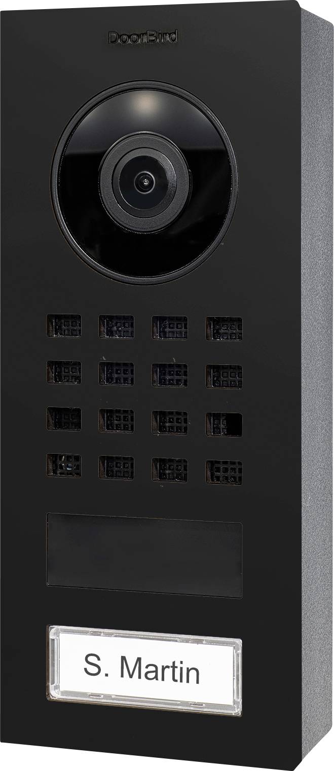 A black video doorbell with a camera lens at the top and speaker grids below. A nameplate at the bottom reads 'S. Martin'.