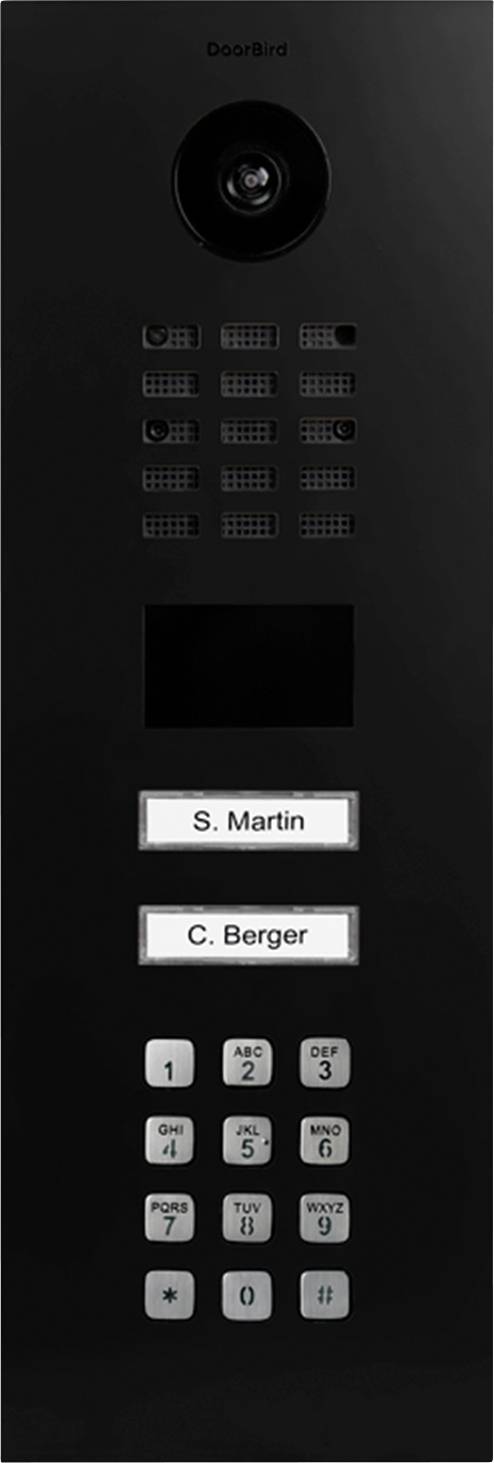 A black intercom panel with a camera, speaker vents, display screen, and two labeled call buttons for 'S. Martin' and 'C. Berger'. Keypad below.