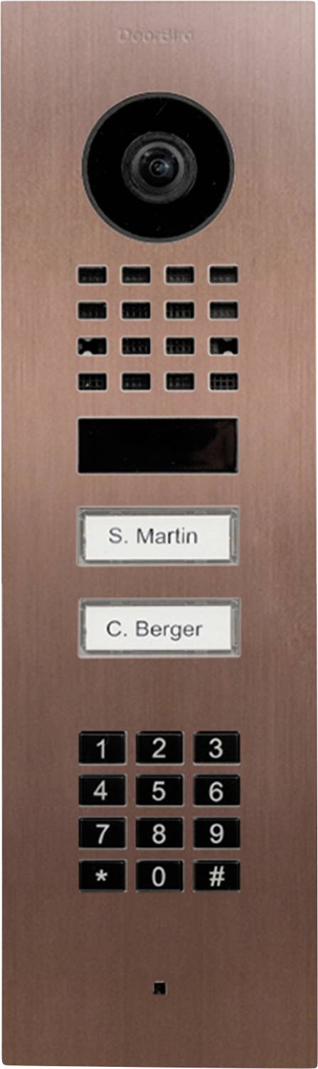 A copper-colored intercom panel with a camera, speaker, buttons for S. Martin and C. Berger, and a numeric keypad for entry access.