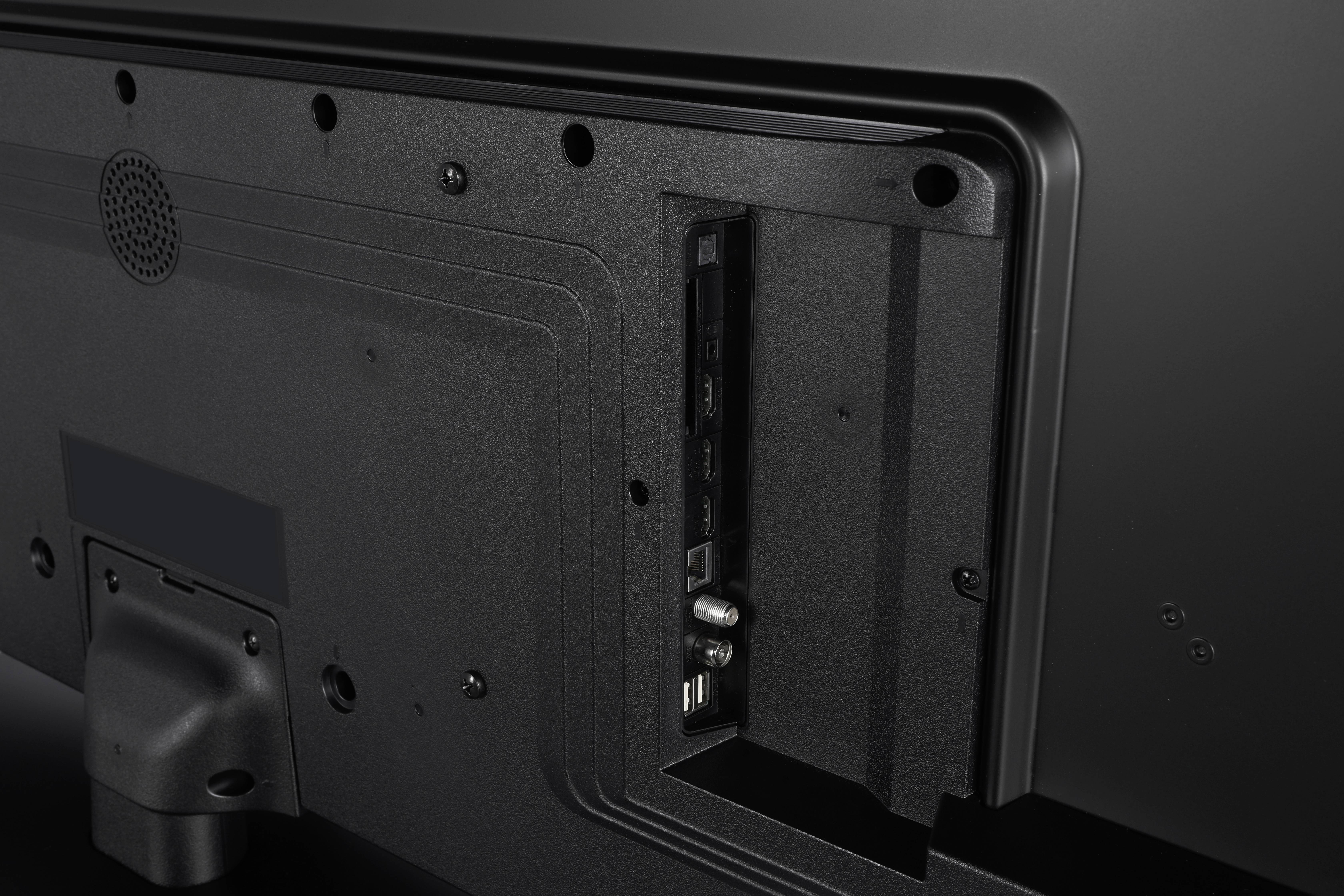 The back panel of a TV showing various ports, including HDMI and USB, in an open compartment, indicating connectivity options.