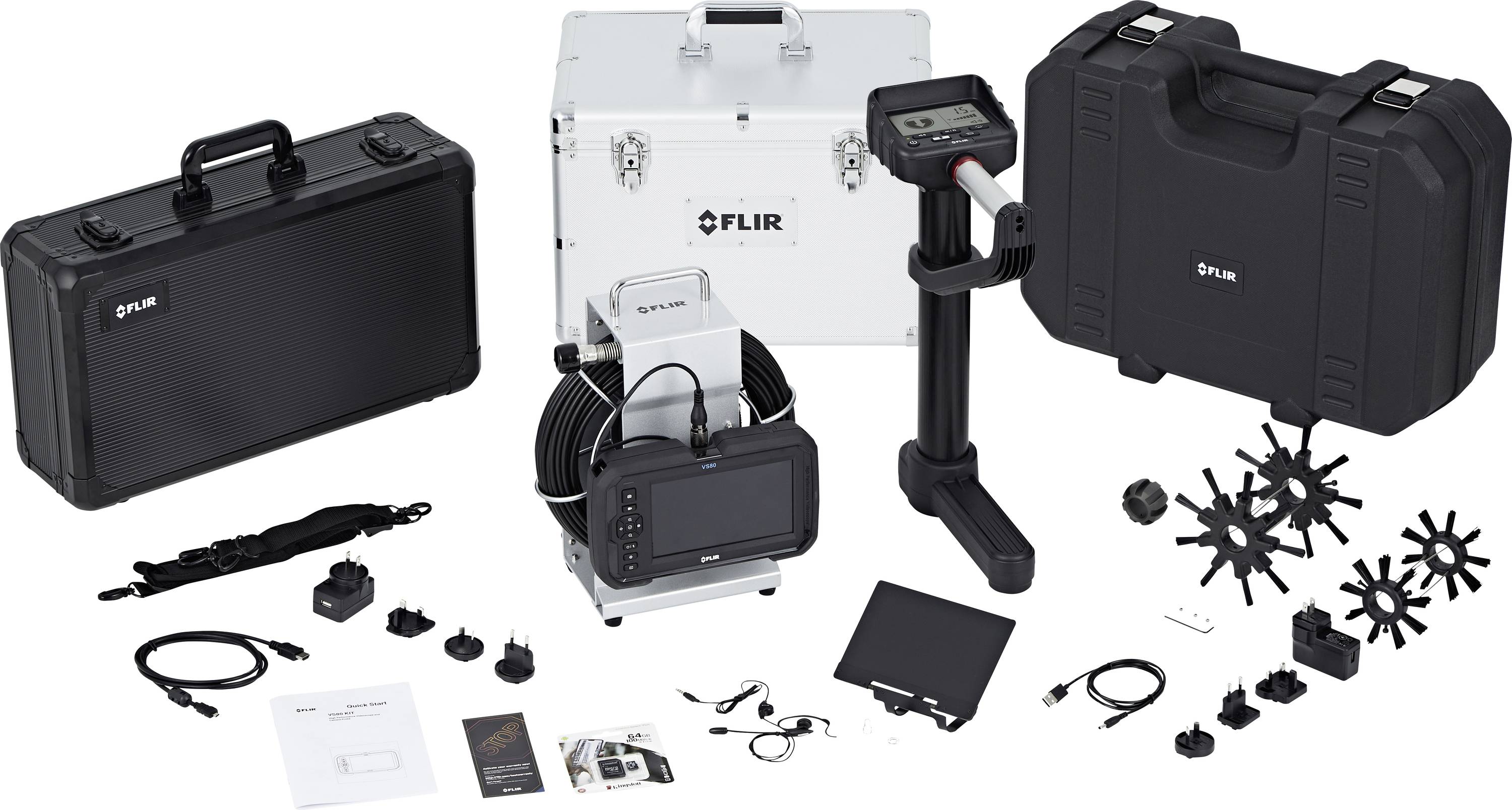 Various FLIR camera components and accessories, including cases, charging adaptors, cables, and a user manual, displayed on a surface.