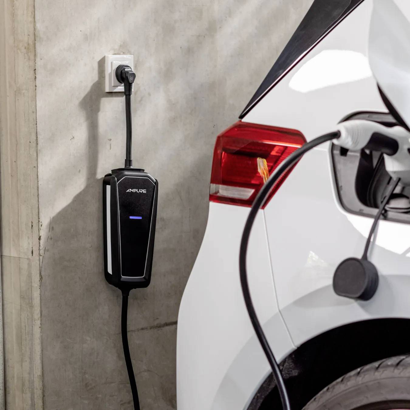 Electric vehicle charging at a station with a cable connected to a white car, wall-mounted charger visible, highlighting EV refueling.