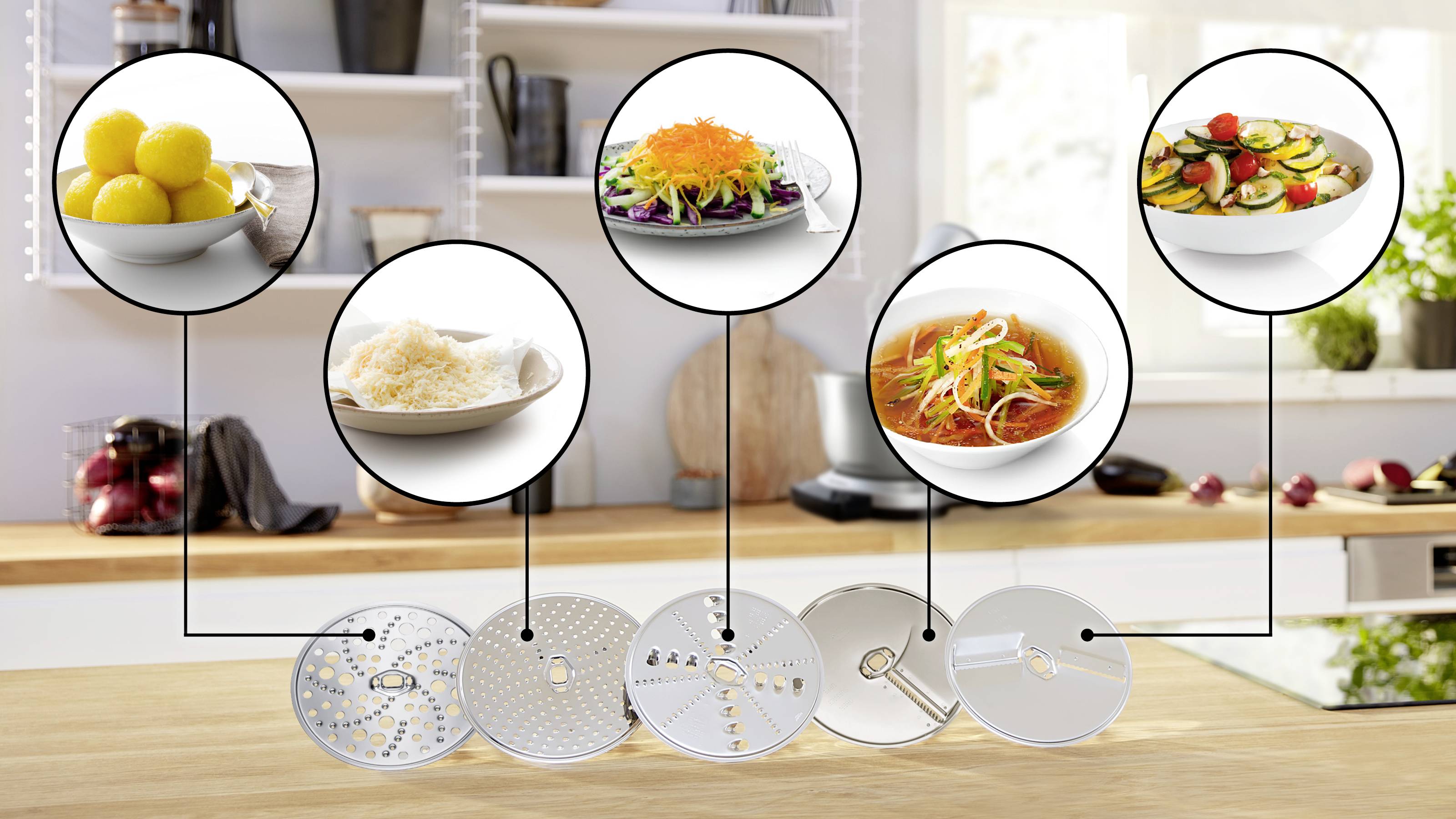 A kitchen counter showcases a food processor with six blades. Each blade is linked to an image demonstrating its use: citrus fruits, shredding salad, grating cheese, slicing carrots, creating noodles, and chopping vegetables.