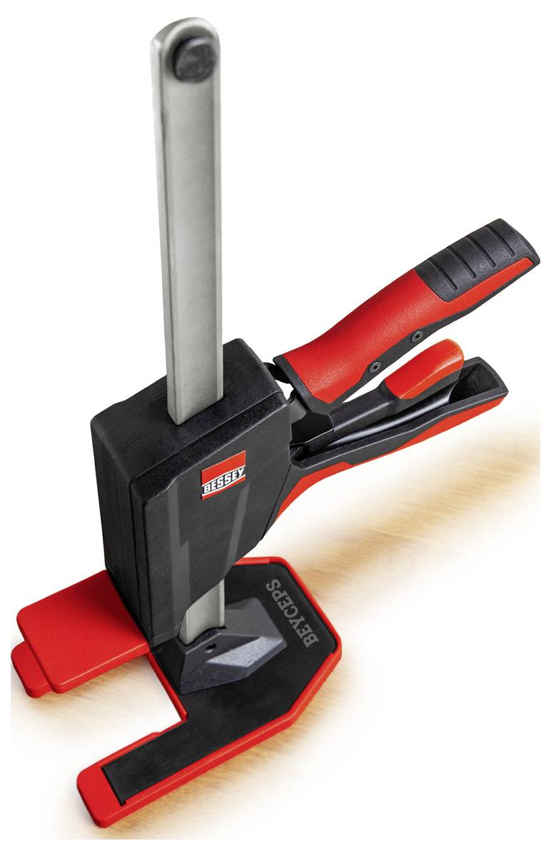 A red and black clamping tool with a handle and a vertical bar, used for holding objects firmly in place.