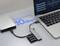 A laptop connected to a hard drive and USB hub, highlighting '10 Gbps Super Speed Transmission' text, emphasizing fast data transfer.
