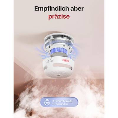 Smoke detector on the ceiling with blue illuminated LED lights. Text 'Sensitive but precise', samples smoke every 10 seconds.