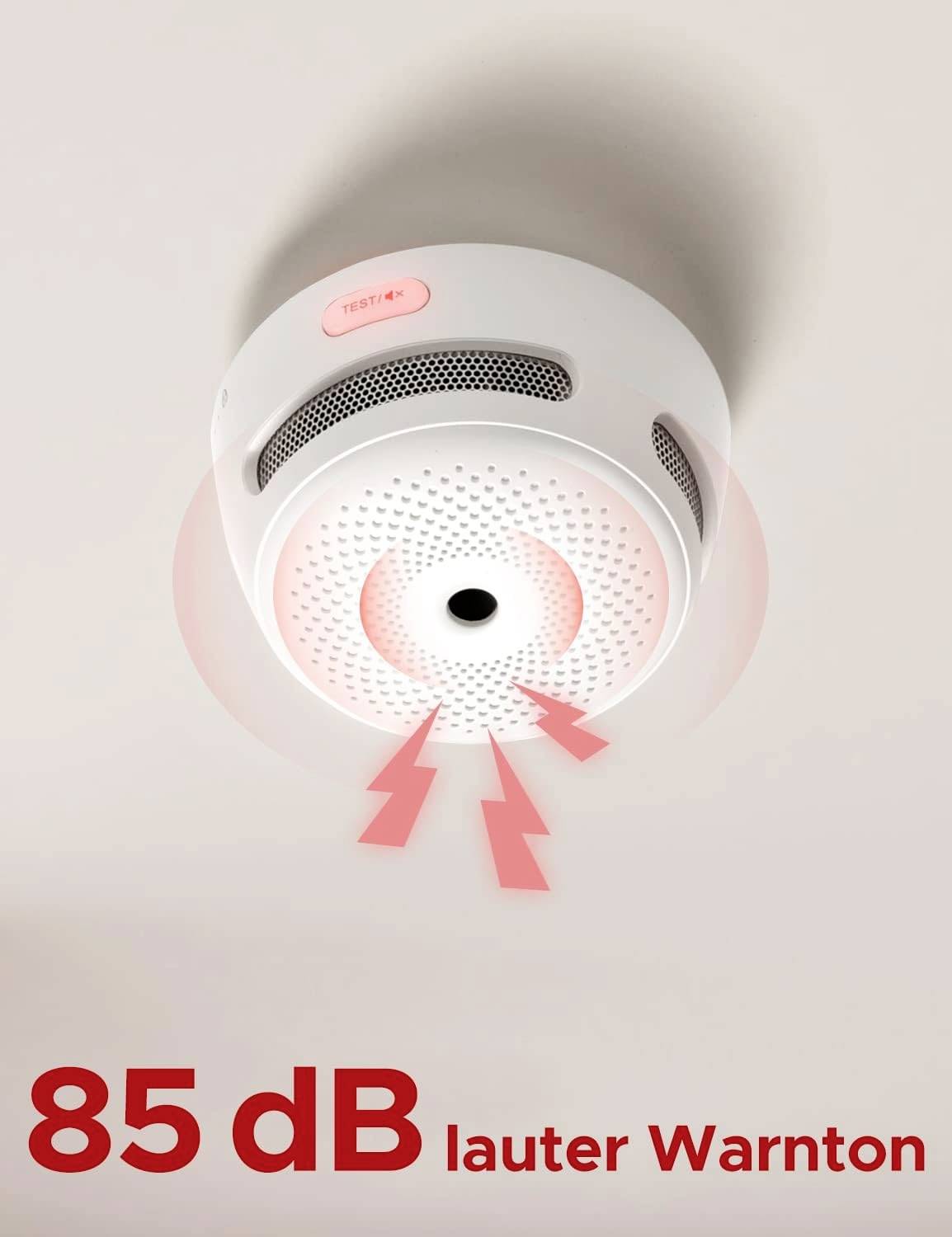 Smoke detector on the ceiling with a red light and heading '85 dB loud warning tone' indicates the volume of the alarm.