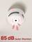Smoke detector on the ceiling with a red light and heading '85 dB loud warning tone' indicates the volume of the alarm.