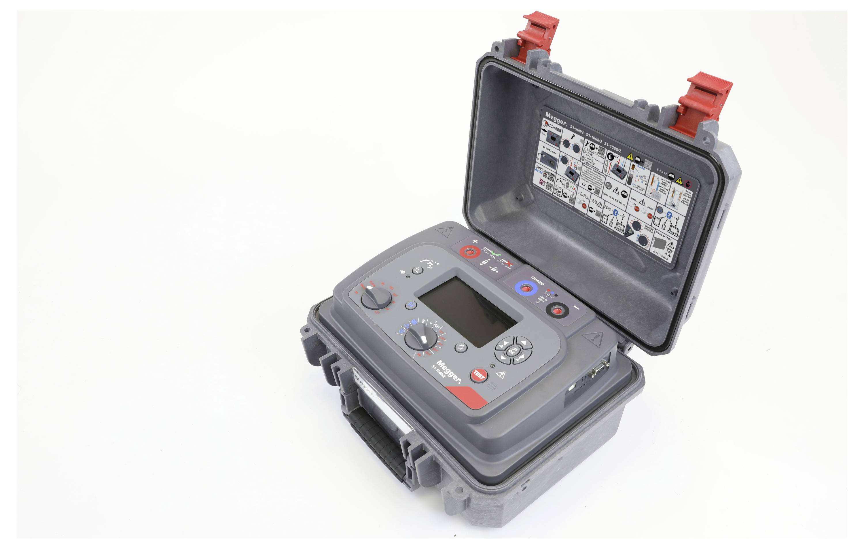 A gray portable testing device with buttons and dials is open, revealing controls and a digital screen. The interior lid shows usage instructions.