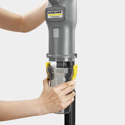 A person empties the dust container of a Karcher cordless vacuum cleaner, focusing on its easy-to-use design.