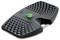 A black, ergonomic footrest with a textured surface and a central green button, designed to improve comfort and posture at a desk.