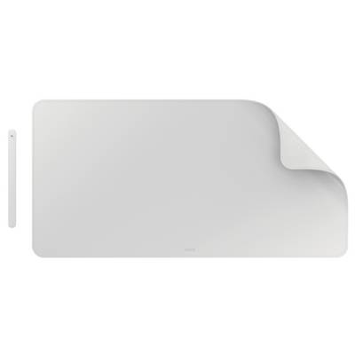 A light gray desk mat with a corner folded up, accompanied by a slim, matching magnetic wireless charging pad on the side.