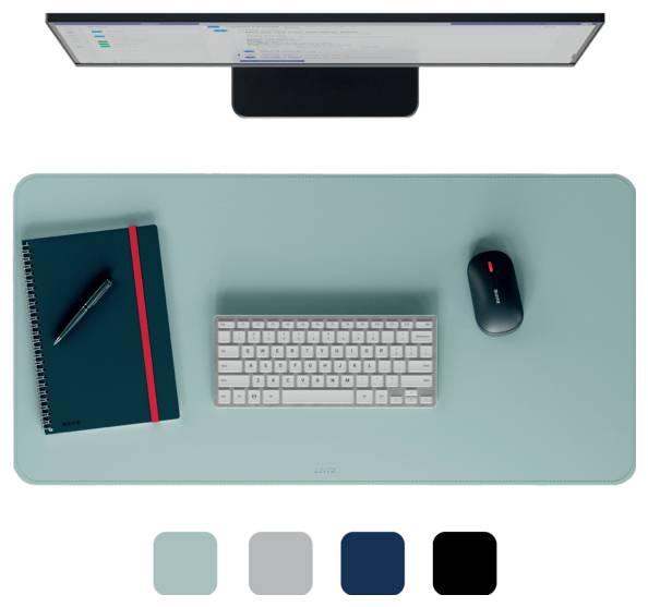 Top-down view of a desk setup. A blue mat holds a notebook, pen, keyboard, and mouse. Four color swatches are shown below: teal, gray, navy, black.