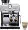 'Espresso machine with grinder, steam wand, gauge, and two glasses with espresso. A latte in a glass on the side.'