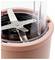 A close-up of a blender blade inside a pink kitchen appliance.