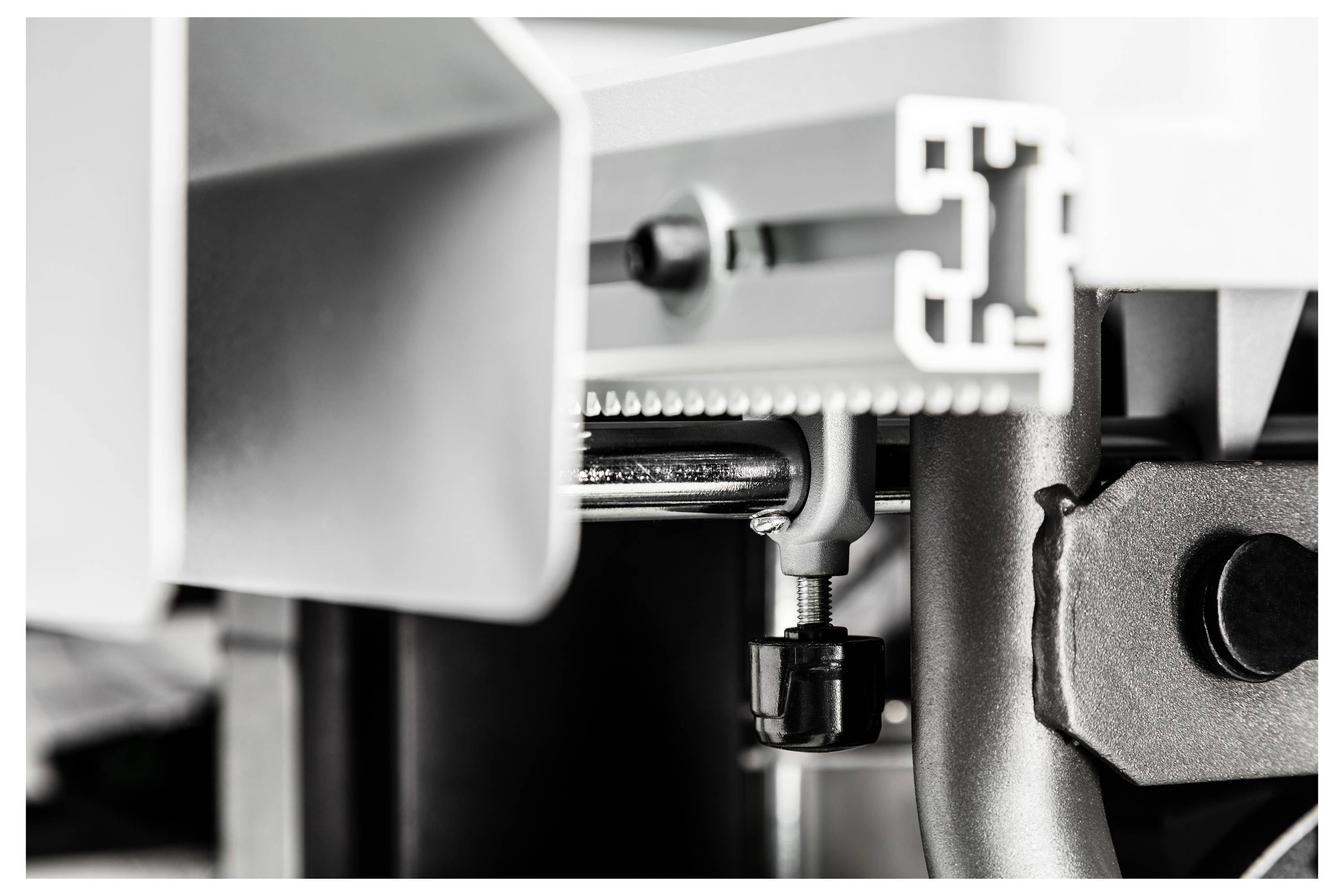 Close-up of an industrial metal assembly, showing a bolt and bracket connection, highlighting mechanical detail and structural design.