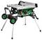 A portable table saw with a green base, silver top, and foldable legs. Equipped with wheels for easy transportation and stability.