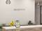 Reception desk with a sign reading 'Weblake's Hotel, Breakfast Time 7:30 to 10:30 AM'. Sunflowers and office organizers on the desk.