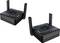 'Two black and dark blue wireless router devices with dual antennas, labeled Omni One, shown from a slightly elevated angle.'