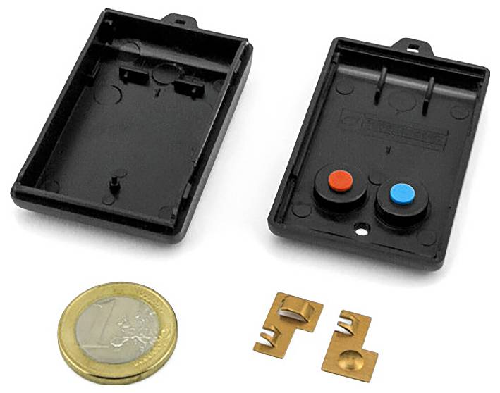 Two small black plastic device housings shown open, with a euro coin and two copper contacts below for scale.