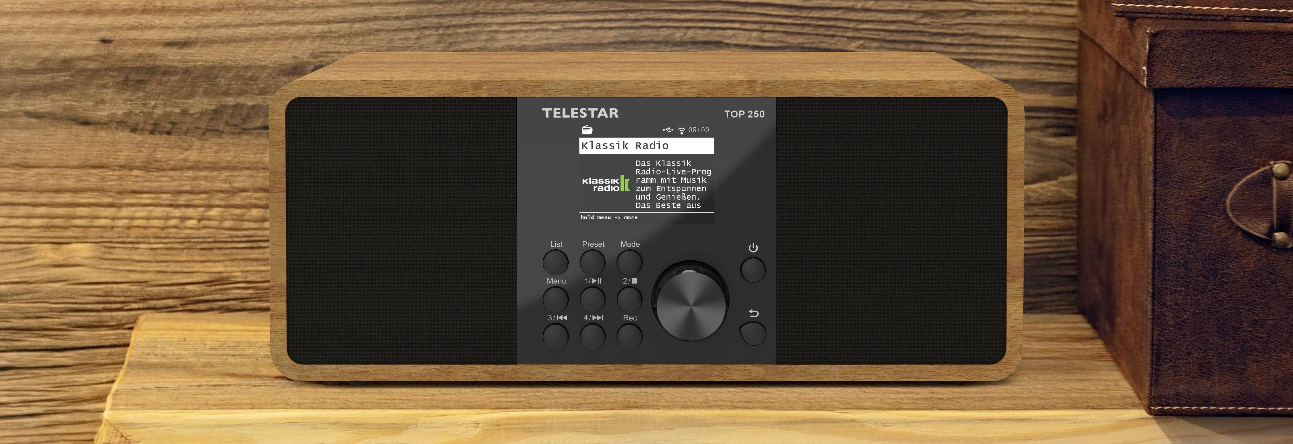 A wood-framed digital radio on a shelf displays 'Classic Radio' on the screen with menu options.