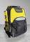A black and yellow backpack with 'STANLEY' on the front, featuring side mesh pockets and several compartments, standing on a gray floor.
