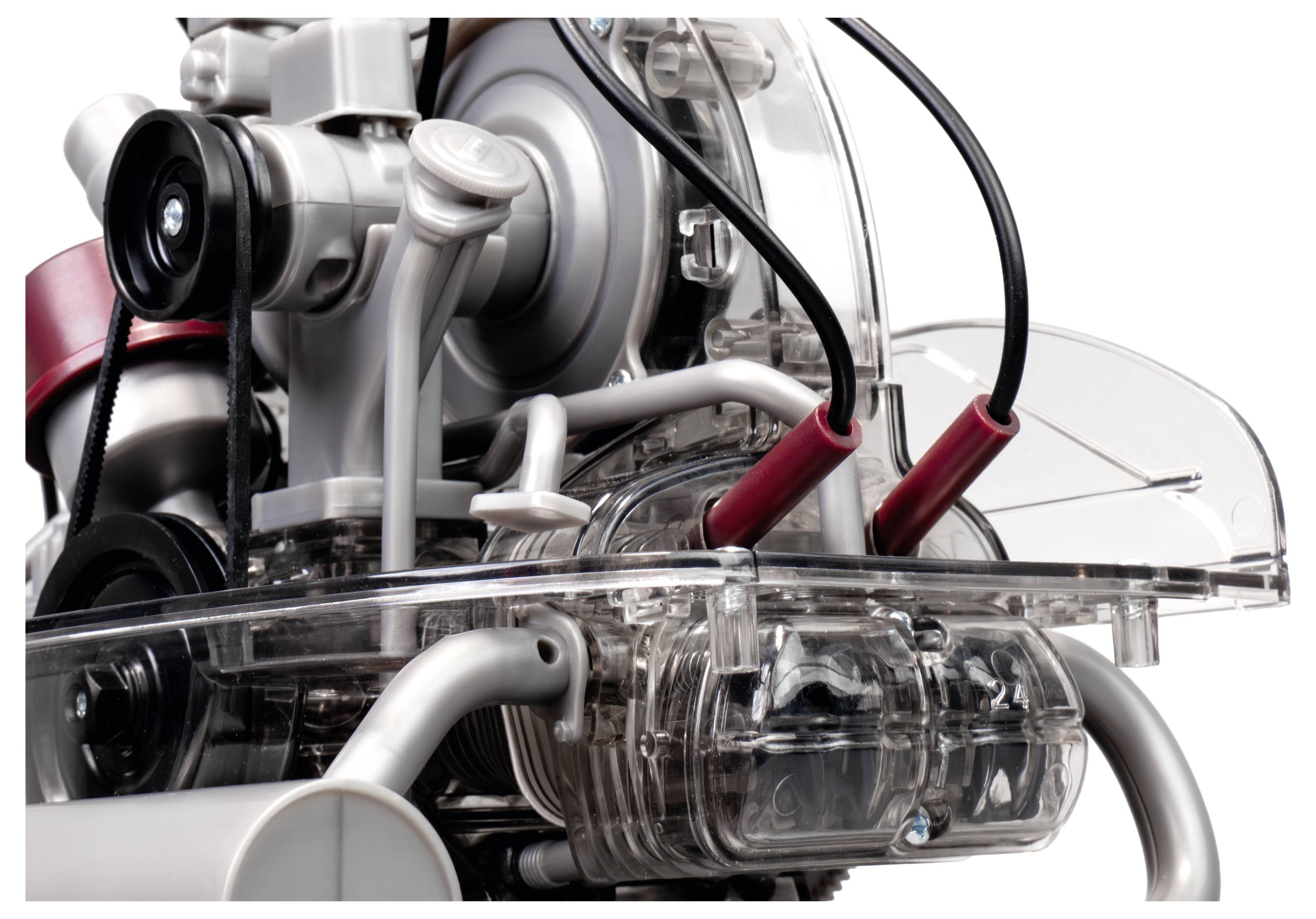 Close-up of a transparent mechanical engine model displaying various components and wiring, illustrating internal structure and parts.