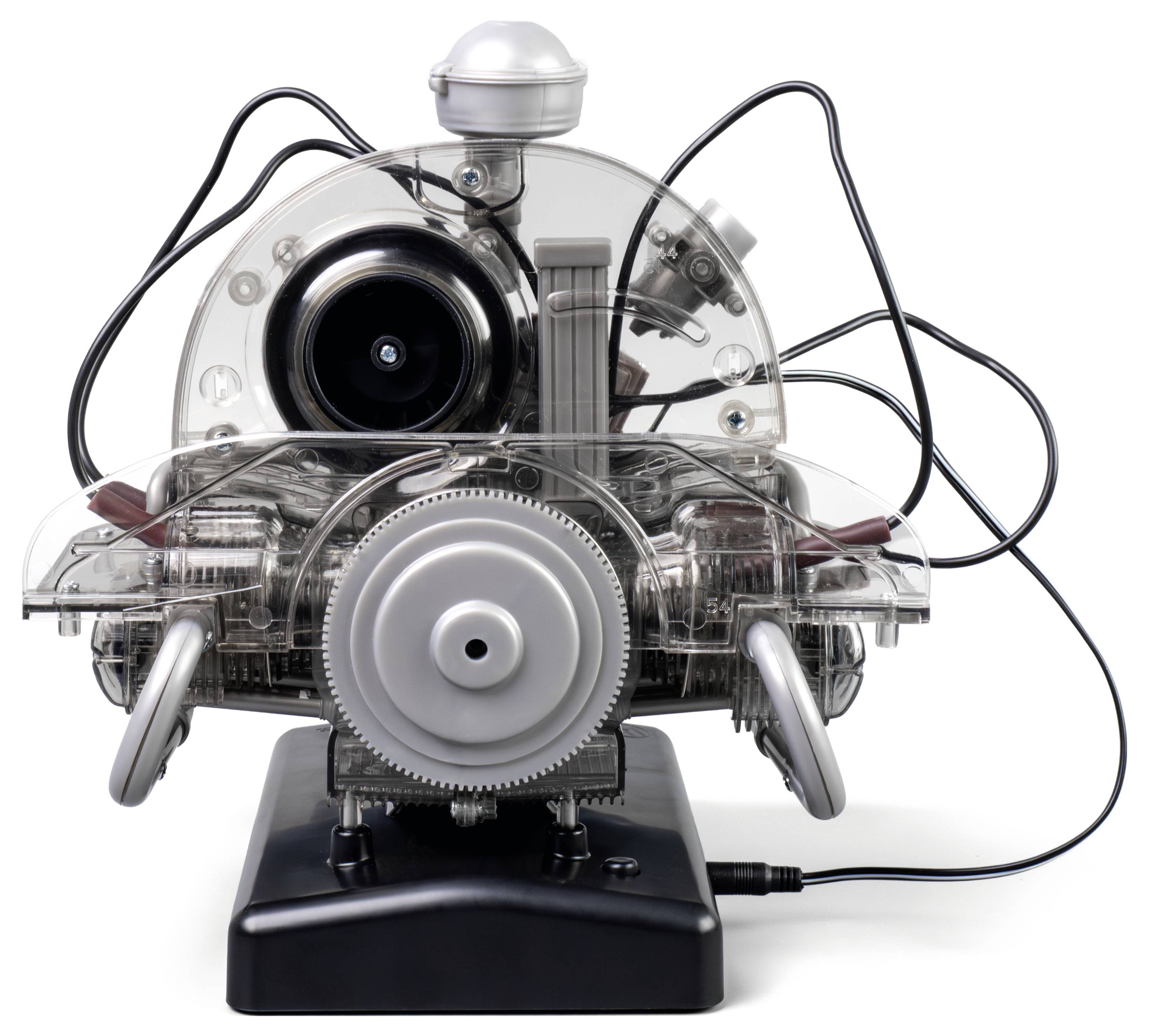 A transparent model engine with visible gears, pistons, and wiring, demonstrating internal mechanics and electrical connections.